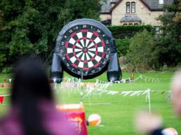 A giant inflatable dart board on a field during summer as part of GOTO Creates inflatable summer.