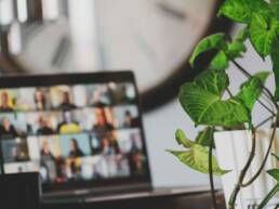 A blurred image of a virtual event on a laptop screen, as part of GOTO Creates Virtual Events