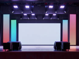 The interior of a conference concert hall or theater with colourful led lights used as GOTO Creates AV screen.