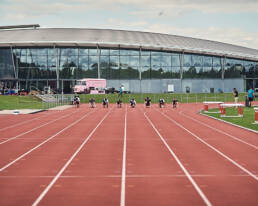 An athletics track at Lee Valley with eight runners on their marks.