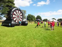 large inflatable target on green grass at corporate event