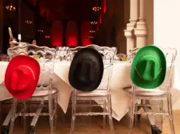 Country colourful hats hanging on chairs at corporate event for Refeyn