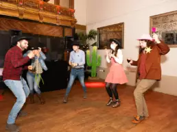 people dancing in Western costumes at corporate event party